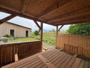 a wooden porch with a view of a barn at Ranč v Landu in Kamýk nad Vltavou