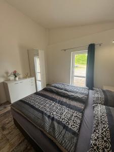 a bedroom with a large bed and a window at Ranč v Landu in Kamýk nad Vltavou