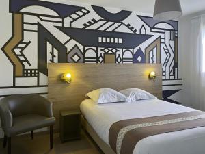 a bedroom with a large bed and a chair at Aparthotel Adagio Bâle Mulhouse Aeroport in Blotzheim +67 photos