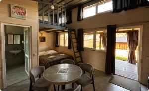 a bedroom with a bed and a table in a room at Prozori Boiky in Lopushanka-Khomyna +61 photos