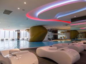 a hotel lobby with a swimming pool and a large pool at Swissotel Sarajevo in Sarajevo