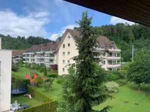 a large apartment building with a tree in the yard at Winterthur in Winterthur