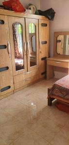 a bedroom with wooden cupboards and a bed and a table at Bethany in Rivière Dragon