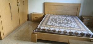 a bedroom with a wooden bed with a quilt on it at Bethany in Rivière Dragon