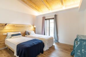 a bedroom with two beds and a window at Casa Romaní– Alojamiento acogedor in Miánegas
