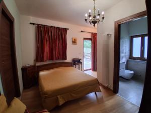 a bedroom with a bed and a chandelier at Agriturismo Cascina Marchesa in Bussoleno