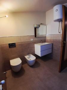 a bathroom with a toilet and a sink at Agriturismo Cascina Marchesa in Bussoleno +17 photos