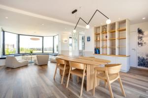 a kitchen and dining room with a wooden table and chairs at Aux flots de la Torche, 3ch in Penmarch