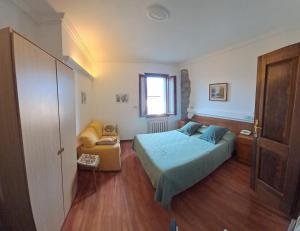 a small bedroom with a bed and a window at Hotel del Corso in Sestola