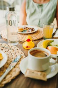 a table topped with a cup of coffee and fruit at 001 HIGOS BEACH BOUTIQUE Singular Hotel Residence in Costa Calma