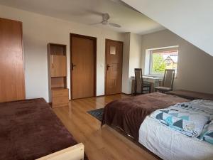 a bedroom with a bed and a dining room at Atticapartament in Kluszkowce
