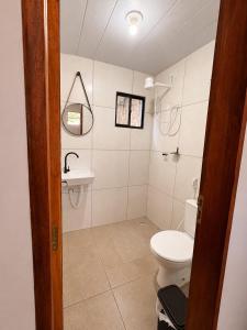 a bathroom with a toilet and a sink at Pousada Serena Jacumã in Jacumã