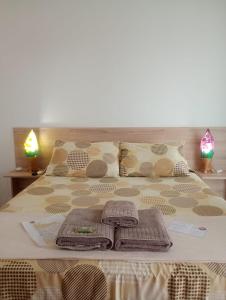 a bed with towels and pillows on it at AYRE GOSTOSO POUSADA in São Miguel do Gostoso