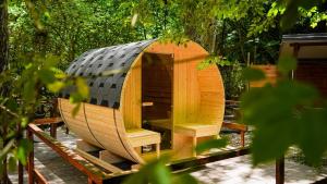 a small wooden boat sitting on a table in a forest at River Tribe Glamping in Laino Borgo +9 photos