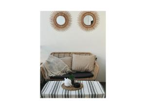 a living room with a couch and two mirrors at Qerret Boutique Studio Apartment in Golem