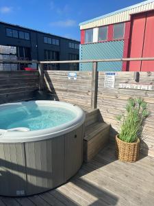 a hot tub on the deck of a building at La Mare Resort in Gothenburg