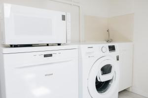 a white laundry room with a washer and dryer at Casa Anastasia Beach Loft in Montesilvano +20 photos