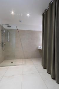 a bathroom with a shower with a glass door at Casa Marina Cargèse in Cargèse +49 photos