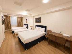 a hotel room with two beds and a desk at ISTANBUL STAY Boutıque Hotel in Istanbul
