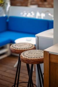 a pair of stools sitting in a room with blue at The Moon Vama Veche in Vama Veche