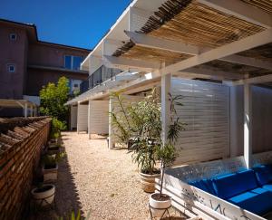 a patio with potted plants and a building at The Moon Vama Veche in Vama Veche