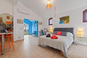 a bedroom with a bed and a kitchen at Studio Lili in Le Diamant +13 photos