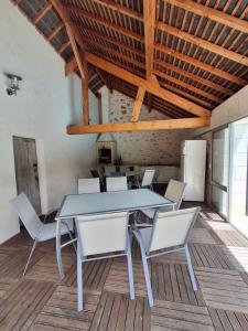 a dining room with a table and white chairs at Chateau de Vaugrignon - Beer Spa in Esvres