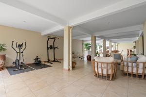 a room with a gym with several exercise bikes at Studio Lili in Le Diamant