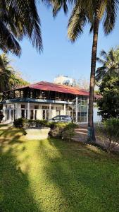 a house with a car parked in front of it at Niwas Villa in Vihur