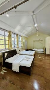 a large room with four beds in it at Niwas Villa in Vihur