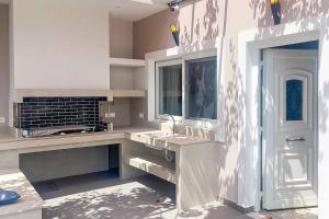 Eine weiße Küche mit Spüle und Arbeitsplatte in der Unterkunft Ether Villa View in Lithakia + 19 Fotos