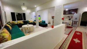 a living room with a couch and a table at Meditation house in El Jadida