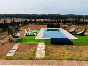 a backyard with a swimming pool and a playground at Meditation house in El Jadida