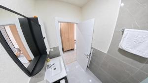 a bathroom with a sink and a mirror at Hotel Centar Sanski Most in Sanski most
