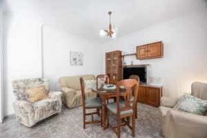 a living room with a table and chairs at En la Gloria in Barbate +26 photos