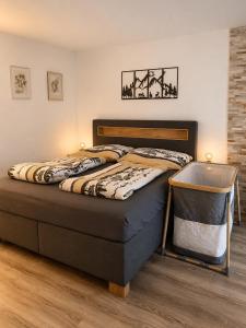 a bedroom with a bed with a nightstand next to it at Mountain Holiday Leukerbad Free Parking and WiFi Playroom 96 in Leukerbad
