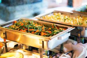 two trays of vegetables are on a buffet at Hotel Clamantis in Yaoundé