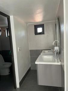 a white bathroom with a sink and a toilet at Bazan Home Mộc Châu in Mộc Châu +54 photos