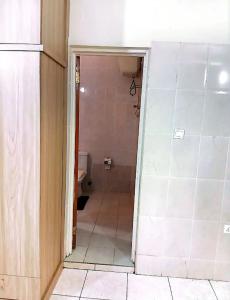 a bathroom with a door open to a bathroom with a toilet at Studio Apt-Osu in Christiansborg +2 photos