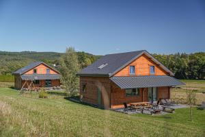 a couple of houses in a field next to a field at Gites de la Semois in Laviot