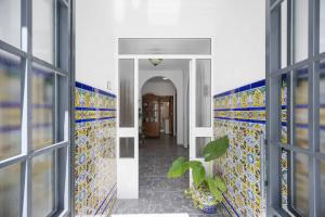 a hallway with colorful tiles on the walls at En la Gloria in Barbate