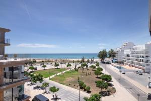 a view of the beach from a building at Parque Atlântico Apartment in Quarteira