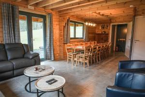 a living room with a couch and a table and chairs at Gites de la Semois in Laviot