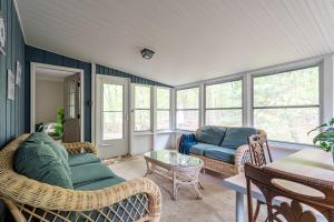 a living room with a couch and a table at Sasquatch Hideaway Game Room Fire Pit in Mushroom Farms