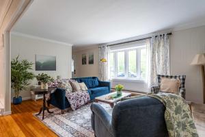 a living room with a blue couch and a table at Sasquatch Hideaway Game Room Fire Pit in Mushroom Farms +41 photos