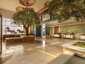 a lobby with a museum with a tree and exhibits at Fairmont Austin in Austin