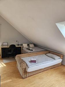 a bedroom with a bed and a desk in a attic at Green Living in Meckenbeuren