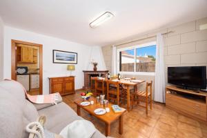 a living room with a couch and a table at Villa Ponent in Port d'Addaia