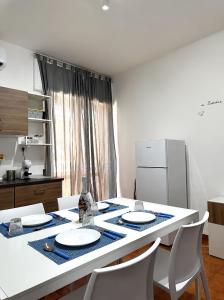 a kitchen with a table with chairs and a refrigerator at Casa Tropea Vibes in Tropea