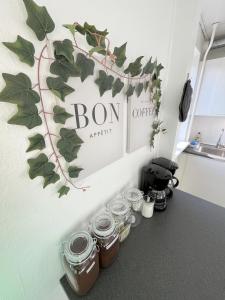 a room with jars and a sign on the wall at Central Large Double Room with free parking in Aalborg